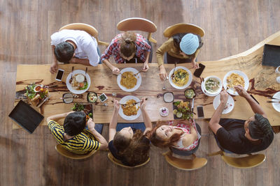 High angle view of people sitting on table