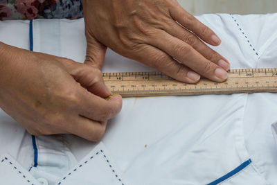 Midsection of tailor measuring textile