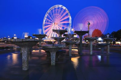 Illuminated ferris wheel at night