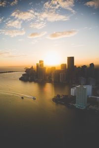 View of city at waterfront during sunset