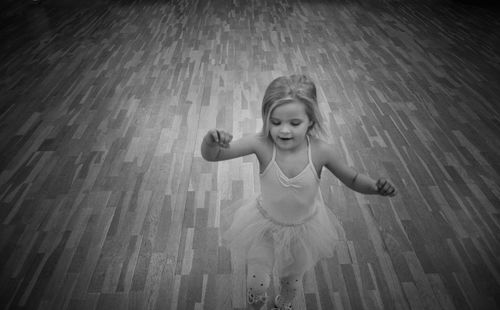 High angle view of girl dancing on hardwood floor