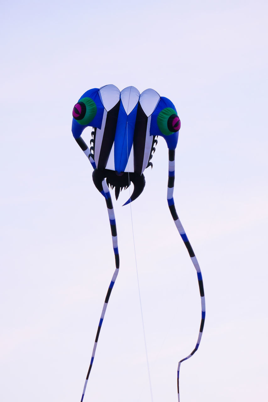 MULTI COLORED UMBRELLAS AGAINST WHITE BACKGROUND