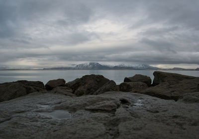 Rocks on beach against sky