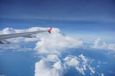 Aerial view of airplane wing against sky