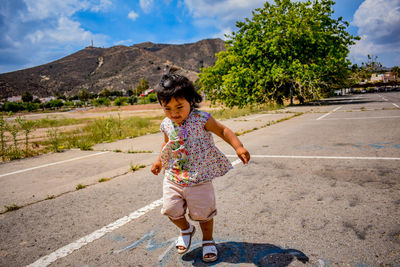 Full length of boy riding horse standing on road