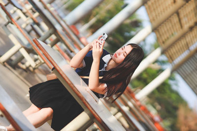 Midsection of woman sitting outdoors