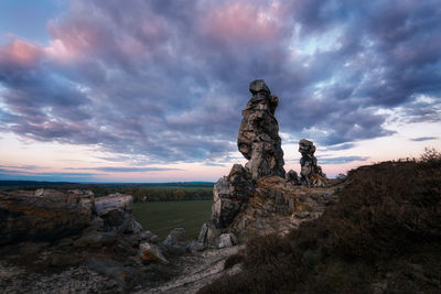 Rock formations on landscape against sky