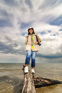 Man standing by sea against sky