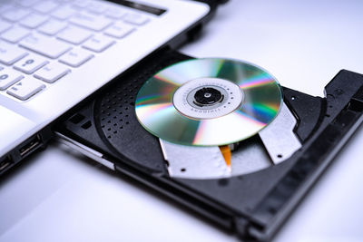 High angle view of compact disc in laptop cd player
