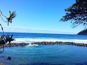 Scenic view of sea against clear blue sky