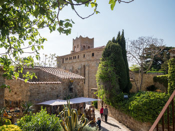 Plants and historic building against sky