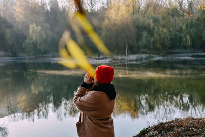 Rear view of woman holding water