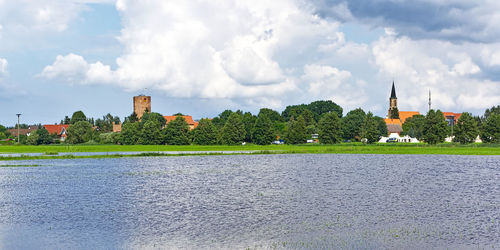 Panoramic view of river by buildings against sky