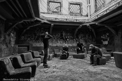 Man sitting in corridor of historical building