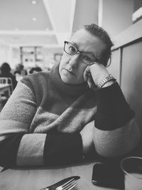 Portrait of young man sitting on table