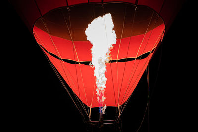 Low angle view of hot air balloon against black background