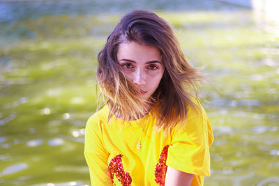 Portrait of young woman on field