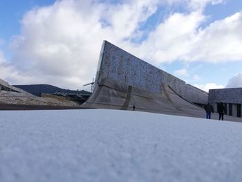 Built structure on snow against sky