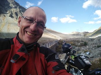 Portrait of smiling man against mountains