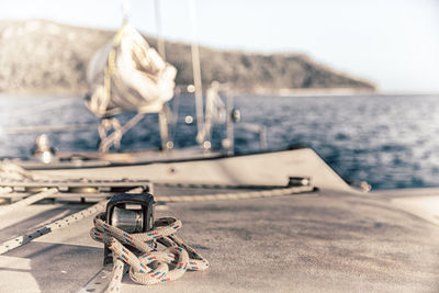 Close-up of rope on beach against sky