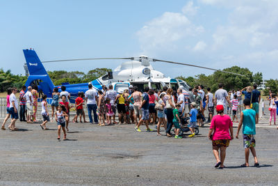 Civilian public visiting a brazilian air force helicopter at the open gates exhibition 