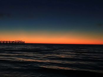 Scenic view of sea against orange sky