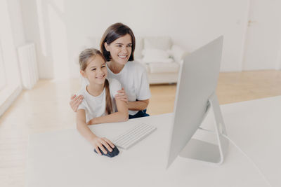 Mother and daughter using computer