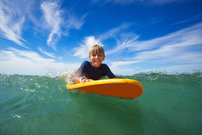 Rear view of woman kayaking in sea