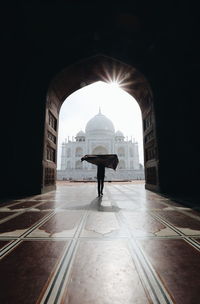 Silhouette person standing against taj mahal