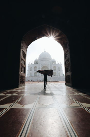 Silhouette person standing against taj mahal