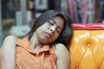 Close-up of woman sleeping on sofa