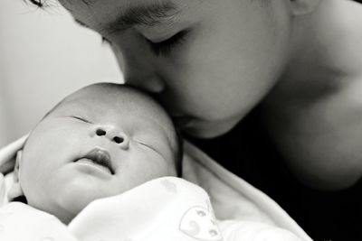 Brother kissing sibling at home