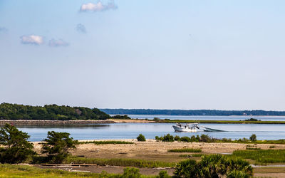 Scenic view of boat in lake against clear sky