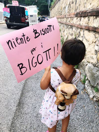 High angle view of girl drawing on road