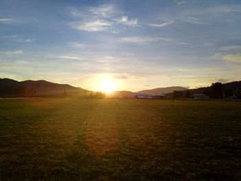 Scenic view of field against sky during sunset