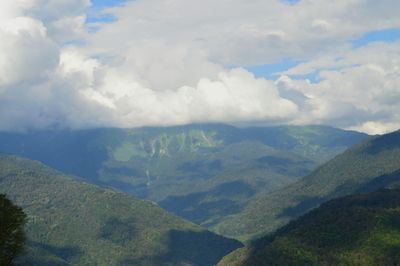 Scenic view of mountains against cloudy sky