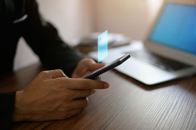 Midsection of man using digital tablet