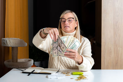 Portrait of young woman sitting at table