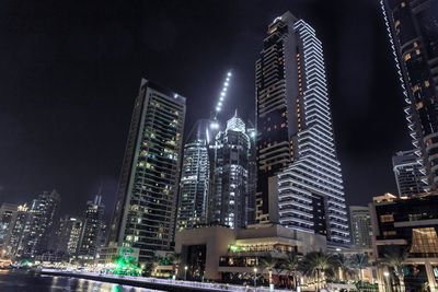 Illuminated buildings in city at night