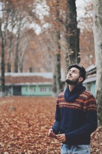 Young man against tree