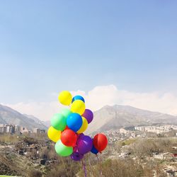 Multi colored hot air balloons against blue sky