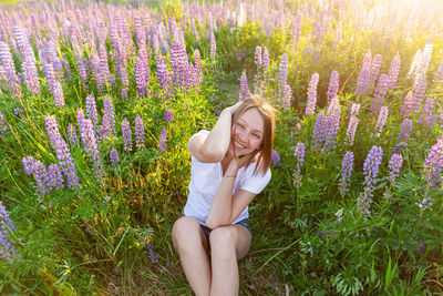 Full length of woman standing amidst plants