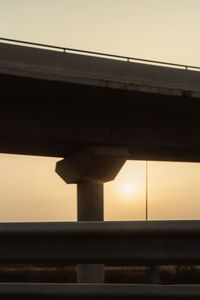 Low angle view of bridge against sky during sunset