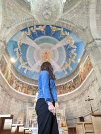 Rear view of woman standing in historic building