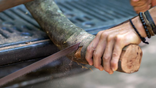 Close-up of man working on wood