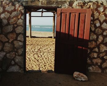 Beach seen through open door