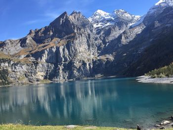 Scenic view of lake and mountains against sky