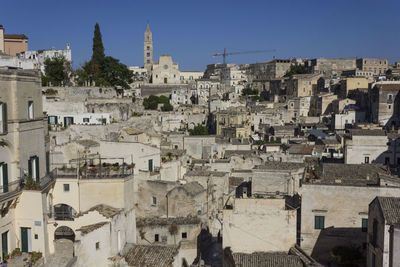 High angle view of buildings in town against sky