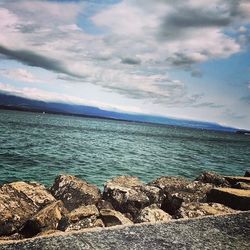 Scenic view of sea against cloudy sky