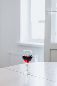 Red wine glass on table